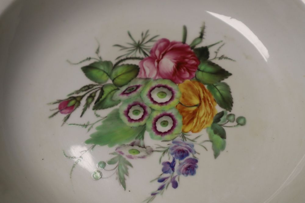 A Chelsea Derby teabowl and saucer painted in the style of Edward Withers with flowers under a blue border and a pair of soup plates